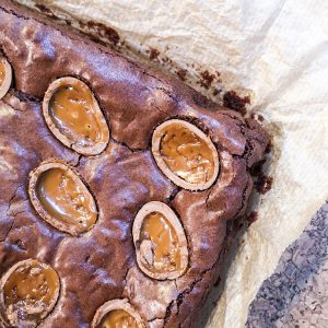 notjustatit easy easter bakes caramel egg brownie flatlay image on cork background